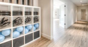 studio and hallway with bookshelves of pilates balls, pilates rings, and foam rollers - pilates for injuries in Barrie